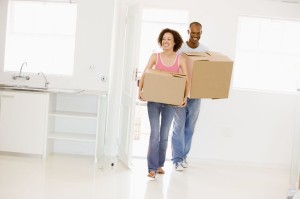 3485780 - couple with boxes moving into new home smiling